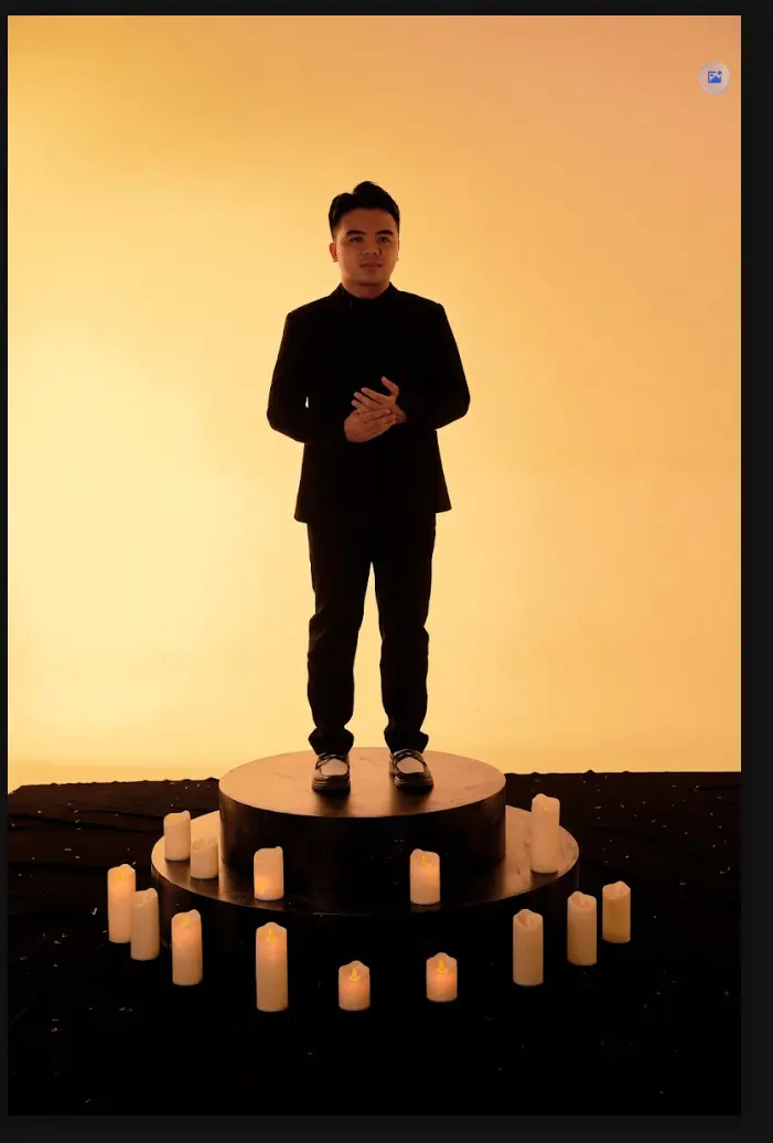 ViAM standing in a warm amber studio setting